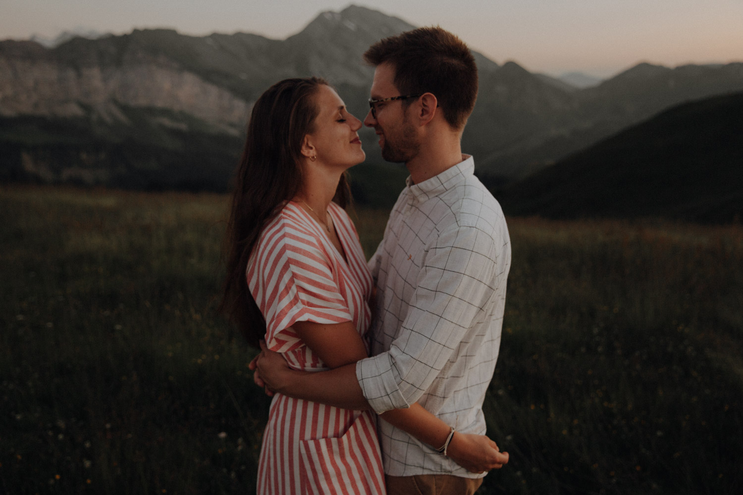 Couple hugging in the Swiss mountains photographed by documentary Swiss wedding photographer