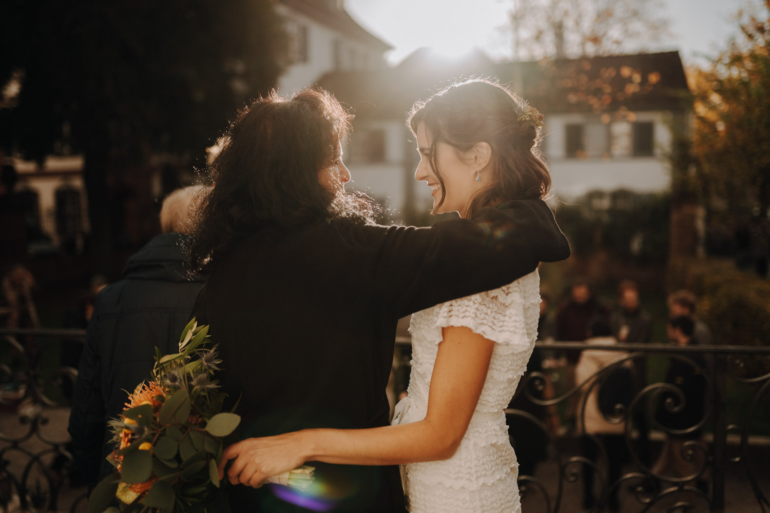 Bride hugs her mother at urban modern wedding in Switzerland