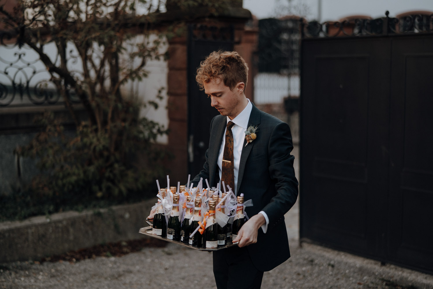 Groom with champagne at wedding in Switzerland