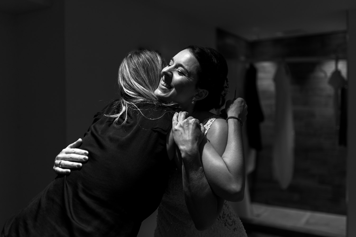 Bride hugging her bridesmaid during getting ready for her Villa Honegg wedding